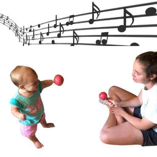 Musical notes on a staff are at the top of the page. A girl toddler shakes a pink maraca with her left hand. She is staring at her mother who is sitting across from her on the floor holding a pink maraca.